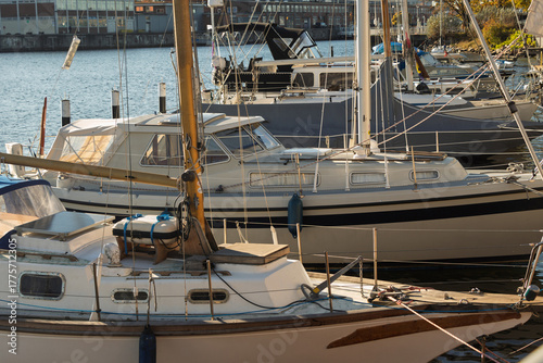 Fototapeta Naklejka Na Ścianę i Meble -  A harbour where white yachts are moored. The Baltic Sea. Blue water. A warm autumn sky.