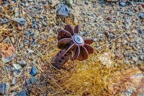 A close-up view of a rusted mortar shell or similar unexploded ordnance