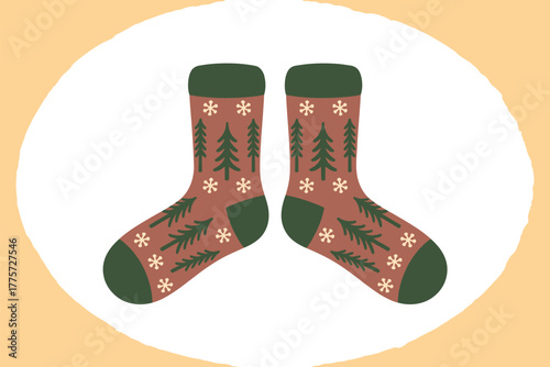 A pair of festive socks adorned with pine trees and snowflakes is displayed.