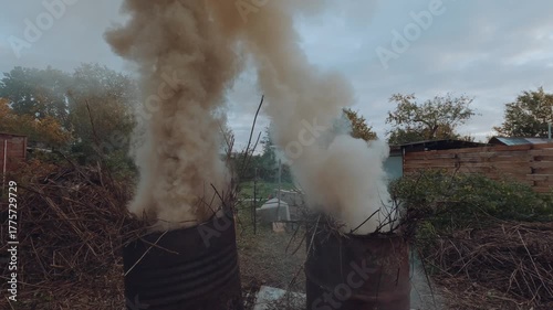 Burning grass in a barrel, burning grass in a cottage, barrels of grass are burning