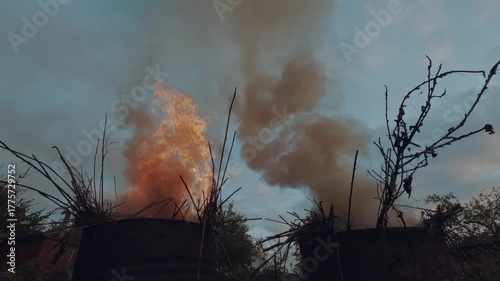 Burning grass in a barrel, burning grass in a cottage, barrels of grass are burning