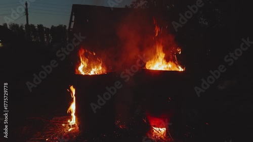 Burning iron barrels, barrels burning at night, flames of fire from barrels