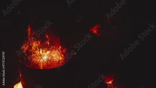 Burning iron barrels, barrels burning at night, flames of fire from barrels