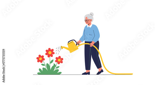Senior woman, with gray hair and glasses, actively waters potted flowers in her garden with a watering can and hose.