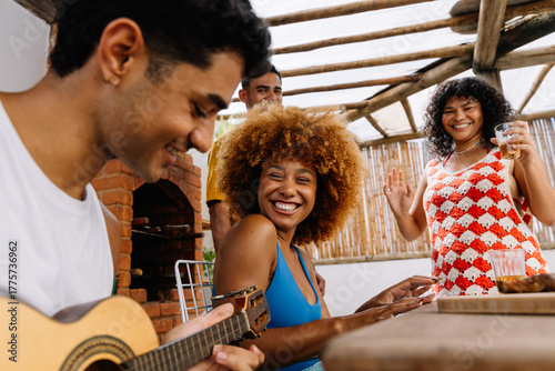 Friends enjoying music and laughter outdoors on a Saturday afternoon