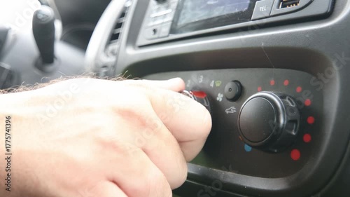 Person turning on the heating in their car