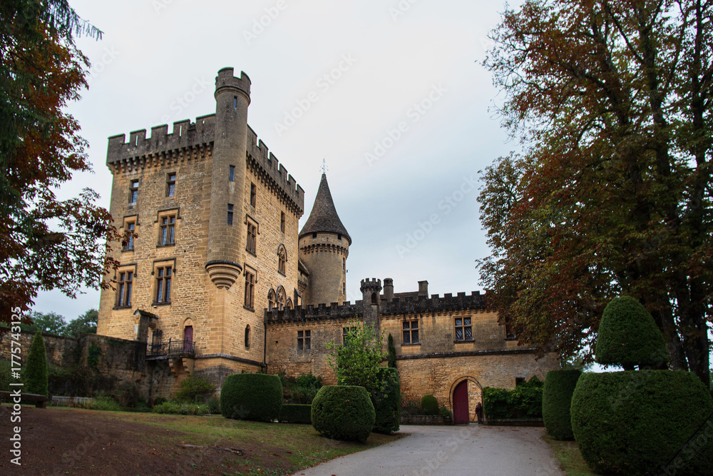 Fototapeta premium Exterior of the medieval castle of Puymartin with its towers and keep in the Dordogne region of France