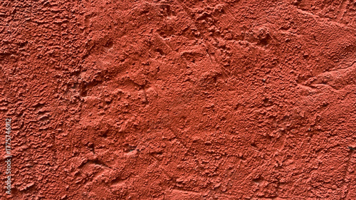 Fotografía Textured red wall with rustic finish seen in an outdoor setting at sunset