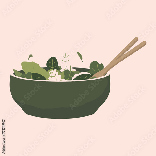 Green salad with wooden chopsticks in a dark green bowl on a pale pink background leafy greens spinach