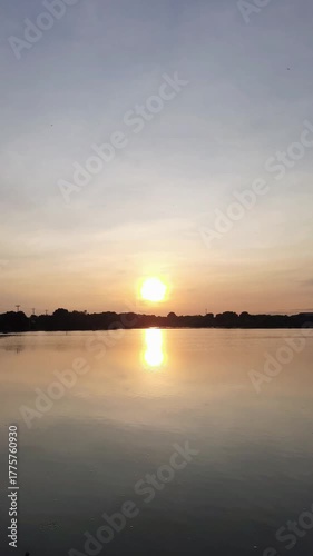 Sunrise in the mangrove forest near the sea and settlements with mountains in the background on the right