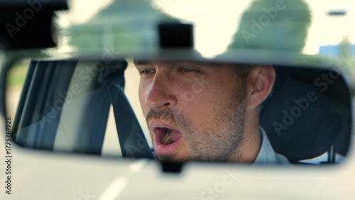 Bild auf Leinwand Close up of young tired man inside the car