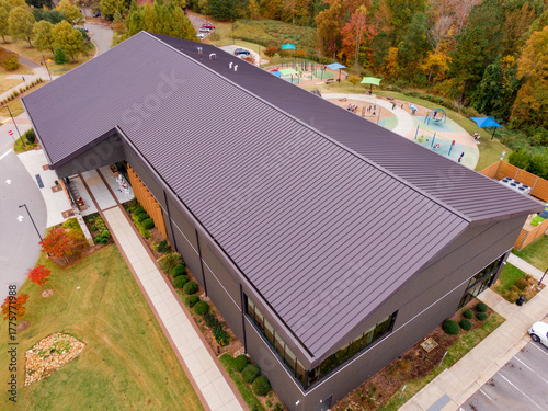 Aerial Drone View of Brown Standing Seam Metal Roof on Modern Commercial Building: Architecture, Roofing, Engineering, Real Estate
