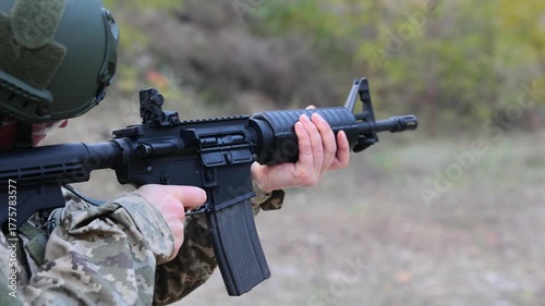 Close-up of a soldier firing an assault rifle. Concept for modern warfare, combat training, and disciplined focus.