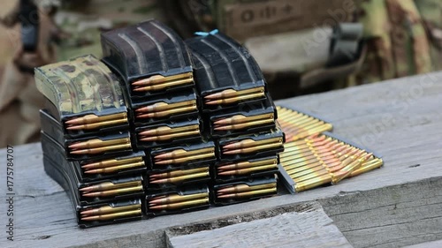 A stockpile of rifle magazines and ammo. Concept for strategic readiness, modern defense, and security operations