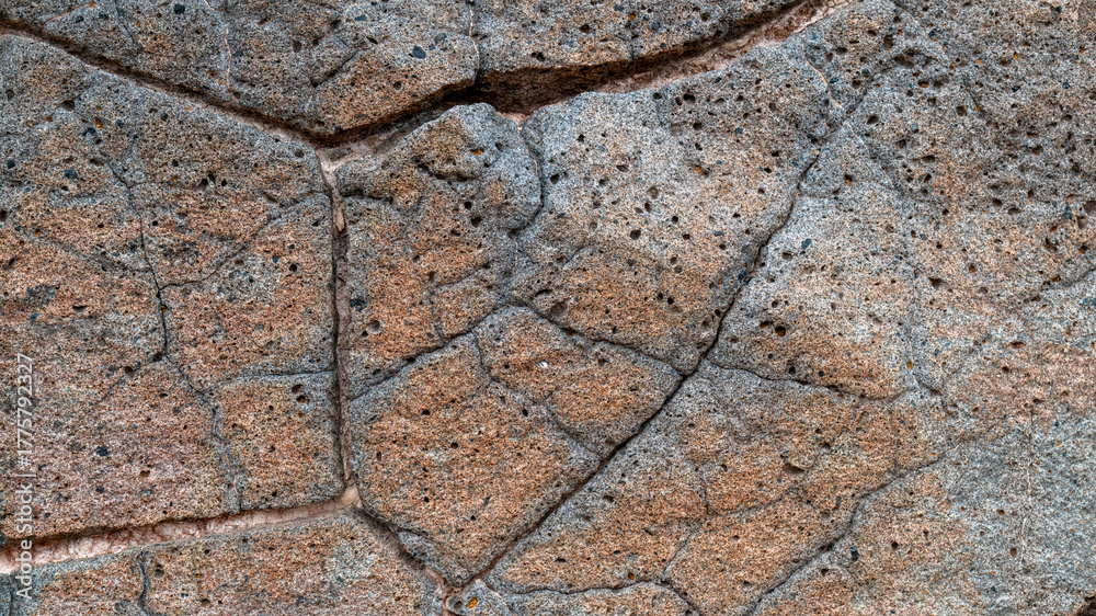 Obraz premium Red volcanic rock with cracks and pores