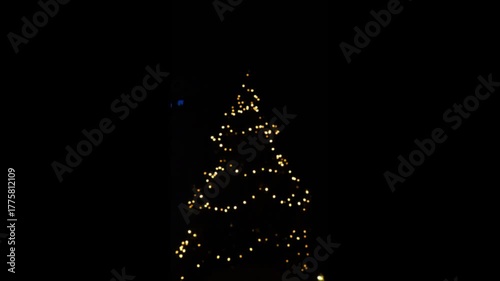 Christmas and New Year mood.Christmas tree silhouette made of garlands. 4k footage