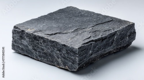 Isolated Dark Gray Granite Block on White Background: Textured Stone Material for Construction and Design
