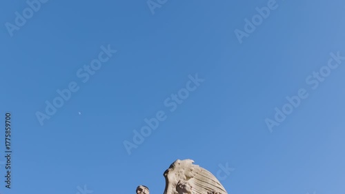 The George Gordon Meade Memorial in Washington D.C. shows its allegorical stone figures set against a clear, bright blue sky, as the camera tilts down.