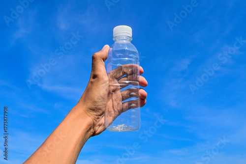 Fotografie Empty plastic bottle holding by hand