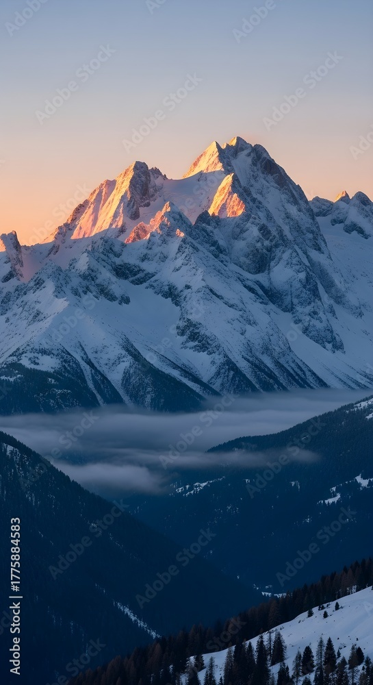 Obraz premium Majestic snow capped mountains bathed in golden sunrise light above misty valleys