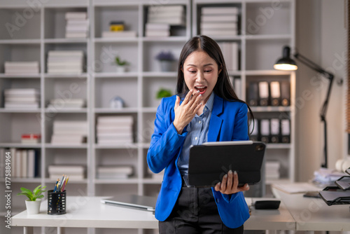 Businesswoman shocked by news on tablet