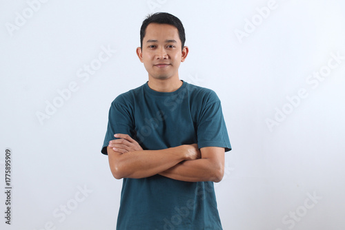 Confident young Asian man smiling with arms crossed isolated on white