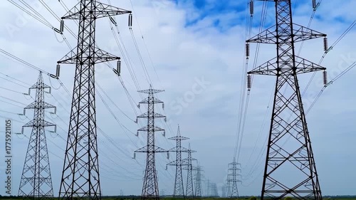 High Voltage Power Lines and Electricity Pylons Under a Blue Sky for Energy Transmission