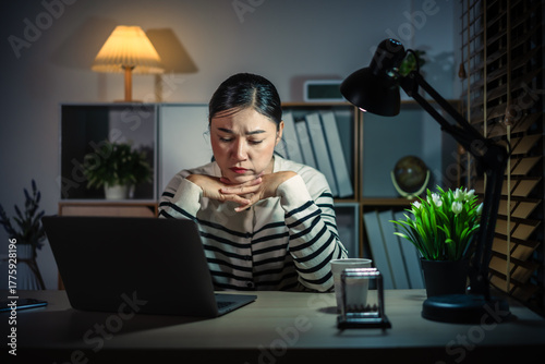 worried woman working with laptop at night