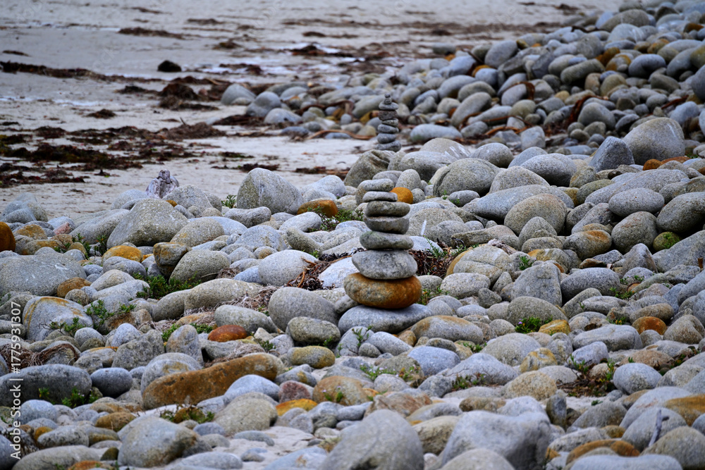 Obraz premium Zen Rock Cairn Stacked Among Smooth Gray Beach Stones
