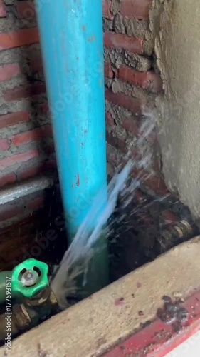 Wallpaper Mural Plumber repairing a broken PVC water pipe with strong water leakage, maintenance and plumbing repair work in progress, fixing damaged water supply system, home repair and renovation concept. Torontodigital.ca