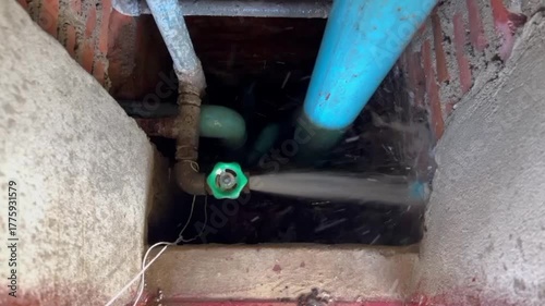 Wallpaper Mural Plumber repairing a broken PVC water pipe with strong water leakage, maintenance and plumbing repair work in progress, fixing damaged water supply system, home repair and renovation concept. Torontodigital.ca