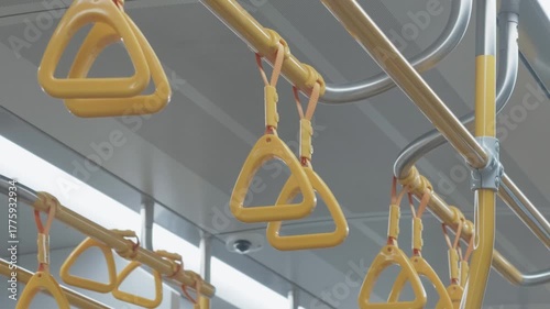 Hand straps on public transport for commuter safety and convenience during peak travel hours