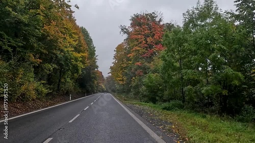 Czechia Bohemia mountain road rain fog POV fast. Czech Republic, Czechia historically Bohemia. Central Europe. Autumn fall season, brilliant colorful leaves along roads and trails. Farm rural area. 