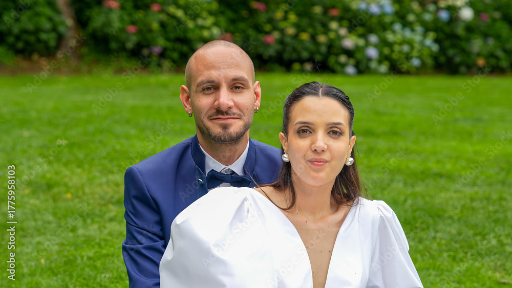 Fototapeta premium Happy couple celebrating their love on a garden lawn during their romantic outdoor wedding party