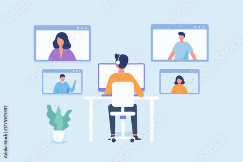 Man wearing headphones attending a video conference call with colleagues on multiple screens