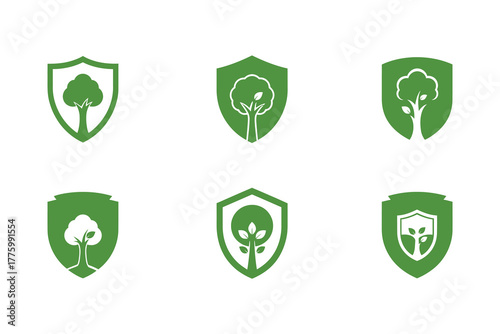 Green shield icons with tree symbols representing nature protection and security.eps
