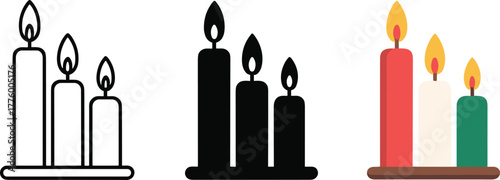 Three lit candles in red white and green on a brown base