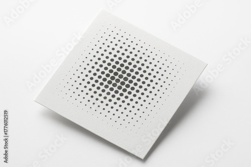 Square sheet of round monochrome screen tones placed diagonally with one corner gently lifted clean graphic studio on white