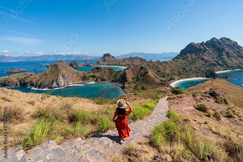 Young female tourist enjoying the beautiful landscape at Padar island in Komodo National Park, Indonesia