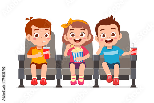 Three happy kids watching a movie eating popcorn and drinking soda in cinema theater