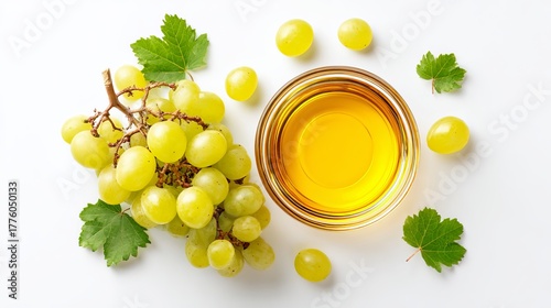 Fresh green grapes and golden grape seed oil in a clear bowl, perfect for healthy lifestyle and culinary projects.