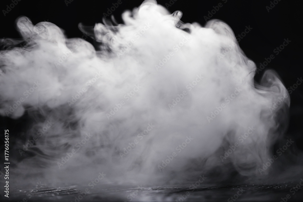 Fototapeta premium White clouds of vapor smoke are isolated on a black background. overlay