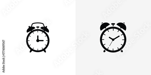 Two Simple Black and White Alarm Clocks Side by Side on a Light Background