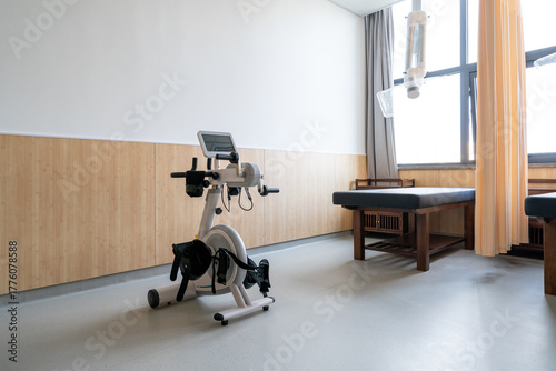 rehabilitation exercise bike with a screen and straps with massage bed in a TCM clinic
