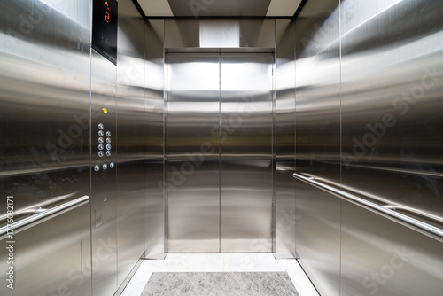 modern elevator with stainless steel walls, control buttons, and a digital floor display, clean and sleek