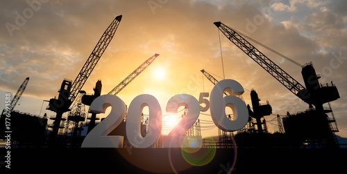 New year 2026 and beginning of success concept,Silhouette construction site,Cranes building construction prepare to welcome the new year 2026 at sunset