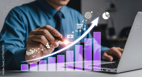 Businessman Working with Virtual Growing Business Chart and Technology Icons on Laptop