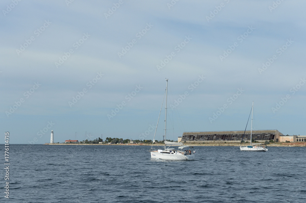 Fototapeta premium Yachts at the Chersonesos lighthouse in Sevastopol, Crimea
