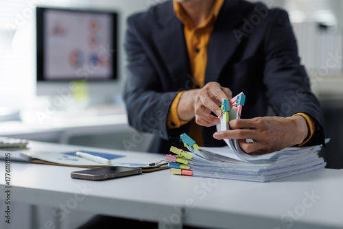 Photography Person organizing business documents with paper clips