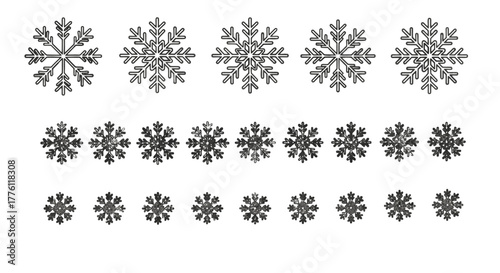 Various snowflake shapes are arranged in rows on a plain white surface, creating a wintery pattern.